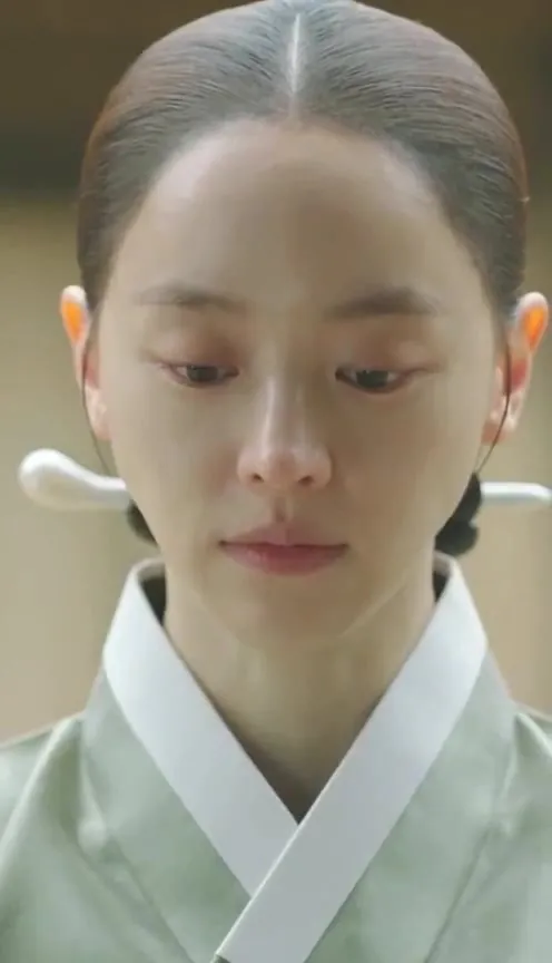 The young wife, eyes lowered
